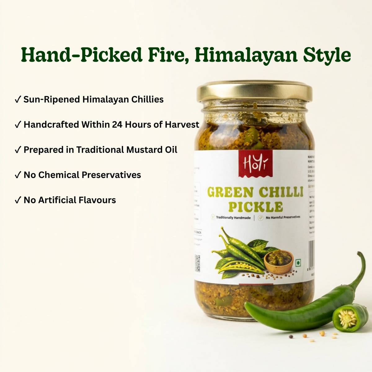 A jar of Hsyf Hand-Picked Fire, Himalayan Style Green Chilli Pickle displayed on a clean off-white background with descriptive text and fresh chili peppers. The product features a gold metal lid, a white label with green and red text, and a clear glass body showing the preserved green chilies and mustard oil inside.