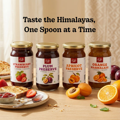 Four jars of Himalayas fruit preserves and marmalade displayed on a wooden table with breakfast toast, sliced strawberries, apricots, and oranges. The text 'Taste the Himalayas, One Spoon at a Time' is written above the products.
