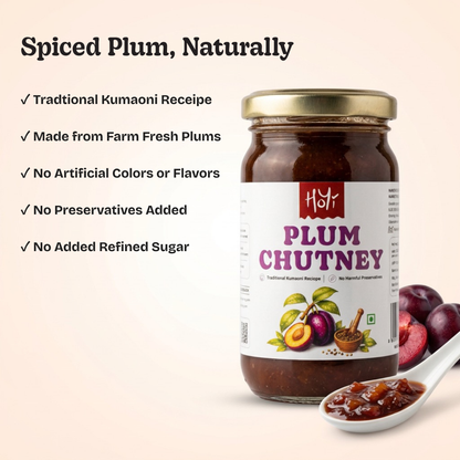 A jar of Hot's Spiced Plum Chutney on a light beige background with promotional text and fresh plums. The jar has a gold lid and a white label with red and purple text, alongside a white spoon containing the dark red chutney.
